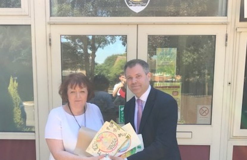 Edward with The Hall School Headteacher and pupils' work