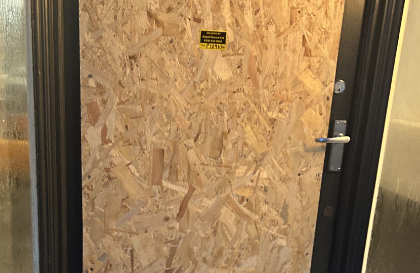 Boarded up shop door