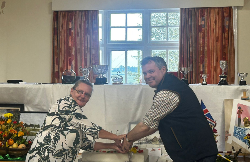 Edward cutting the anniversary cake in Hoby with Society President Vida Gregory