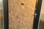 Boarded up shop door