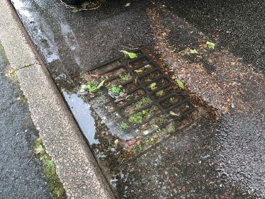 Flooded street drains in Birstall