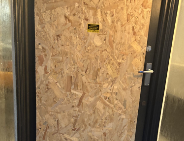 Boarded up shop door